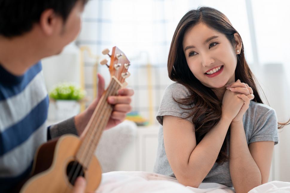 Free Image of Man playing ukelele for his love 