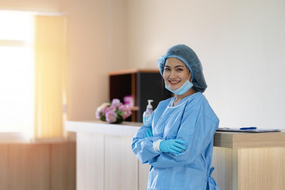 Free Image of Woman doctor wearing surgical face mask, taking a break 