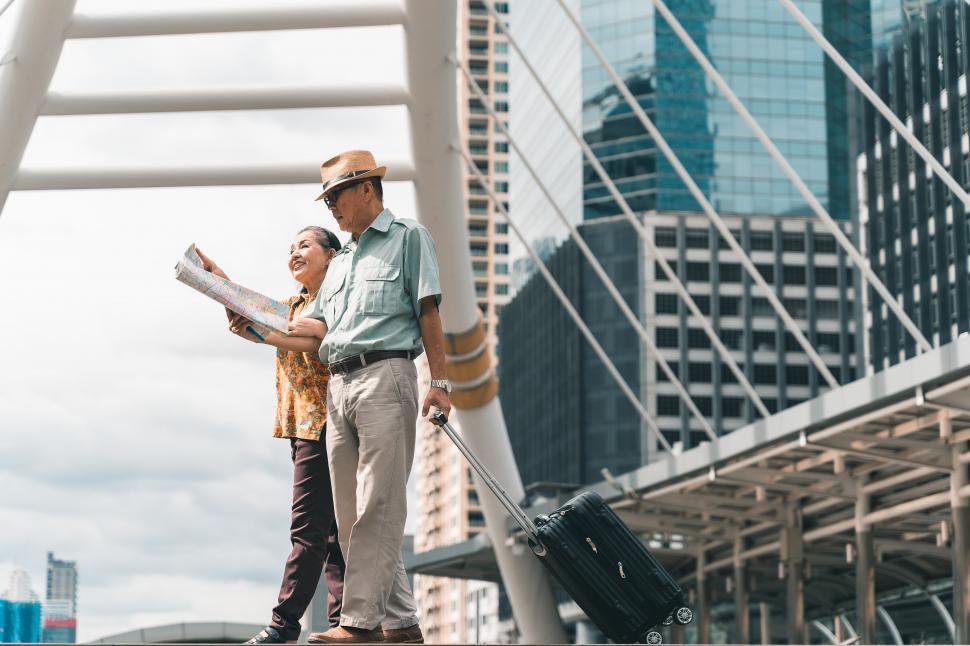 Free Image of A couple of elderly tourists visiting a city 