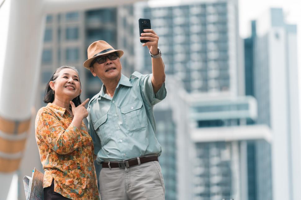 Download Free Stock Photo of Senior couple visiting the city and taking selfie 
