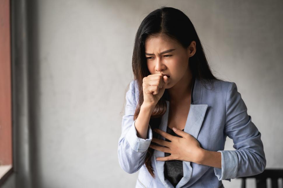 Download Free Stock Photo of Woman with a cold and cough 