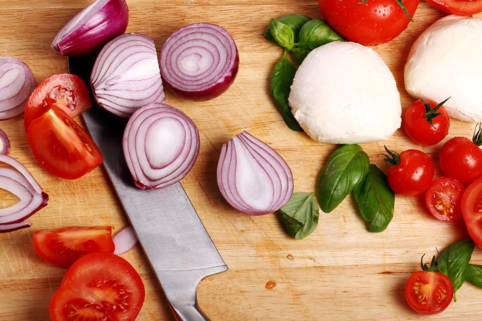 Free Image of Tomatoes, basil and mozzarella on wooden board 