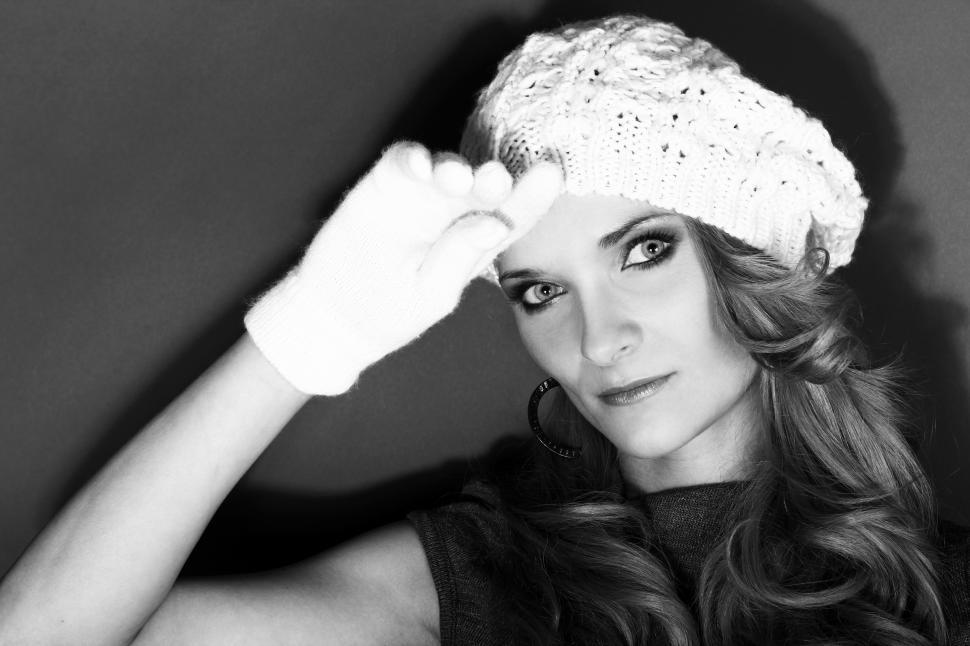 Free Image of Black and white photo of woman in white hat and gloves 