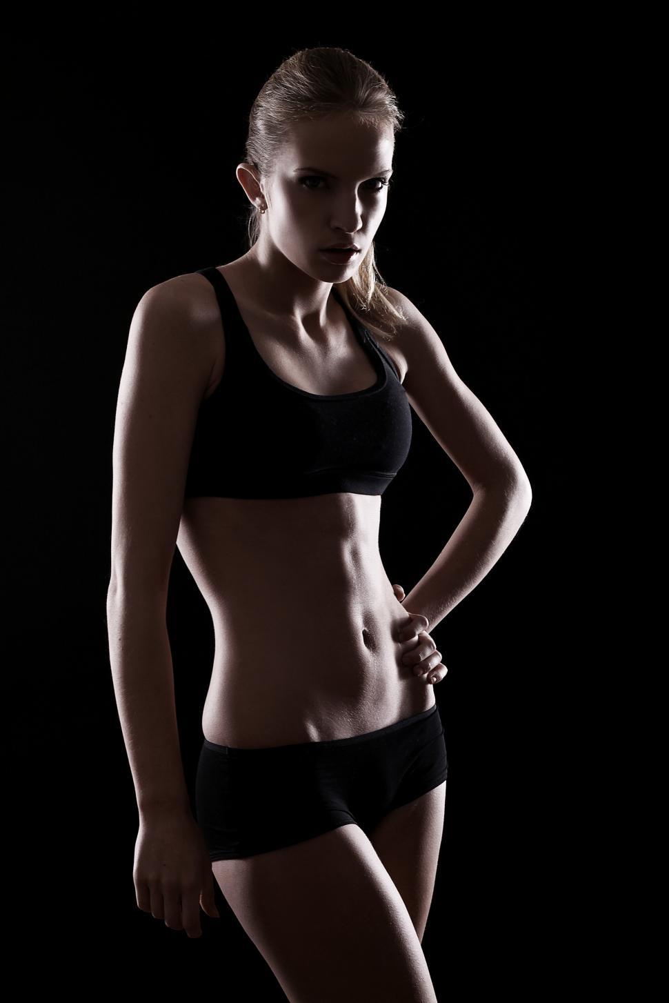 Free Image of Young fit woman in dark setting 