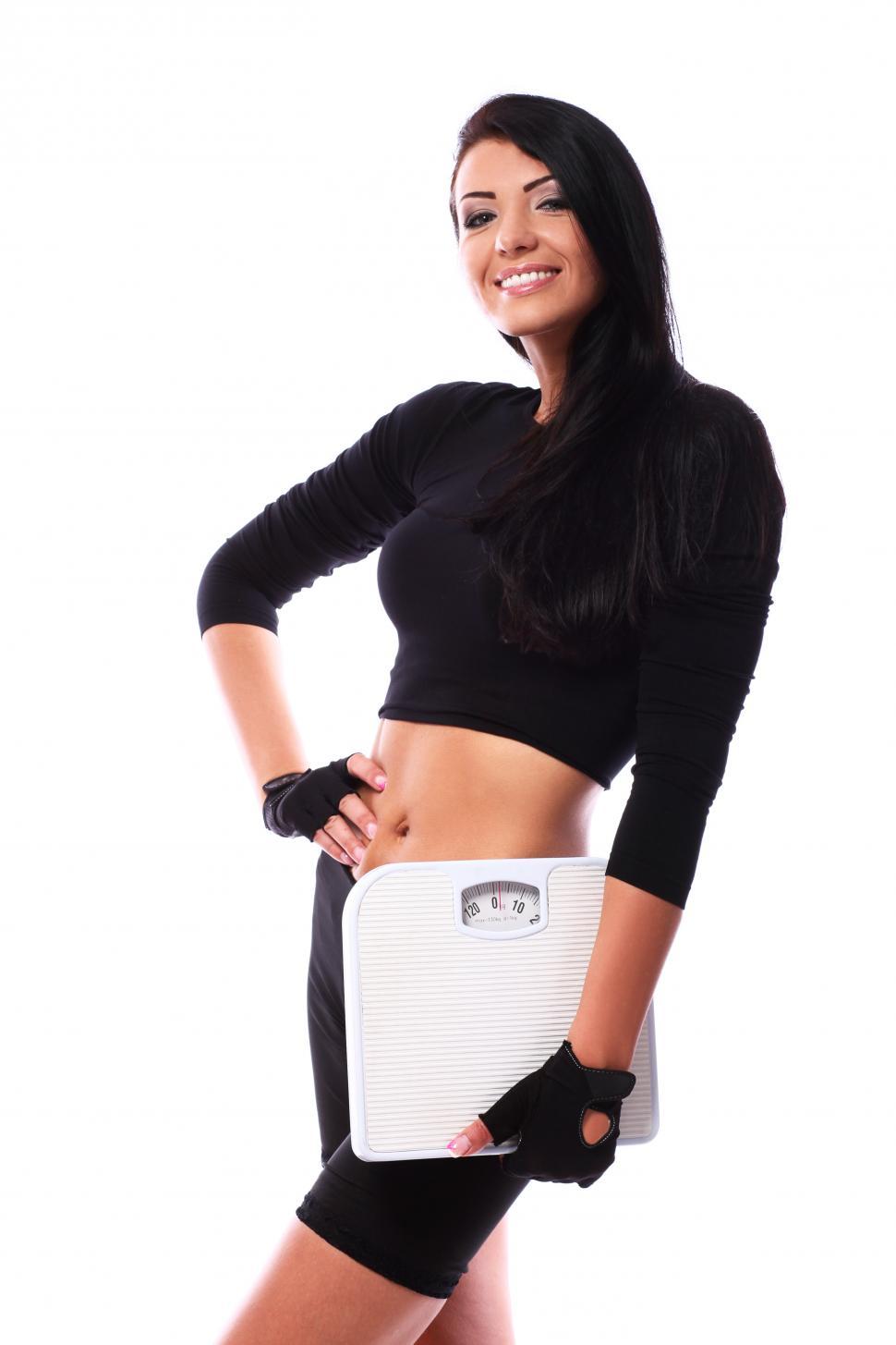 Free Image of Happy fitness girl holding a scale 