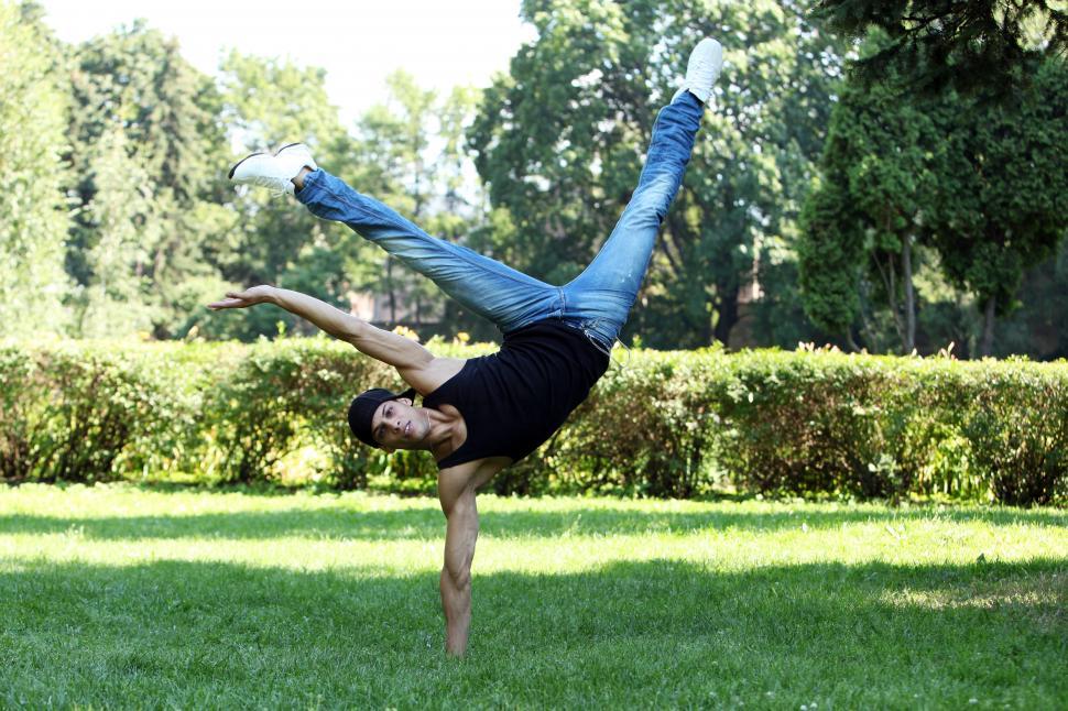 Free Image of Acrobatic guy breakdancing in the park 