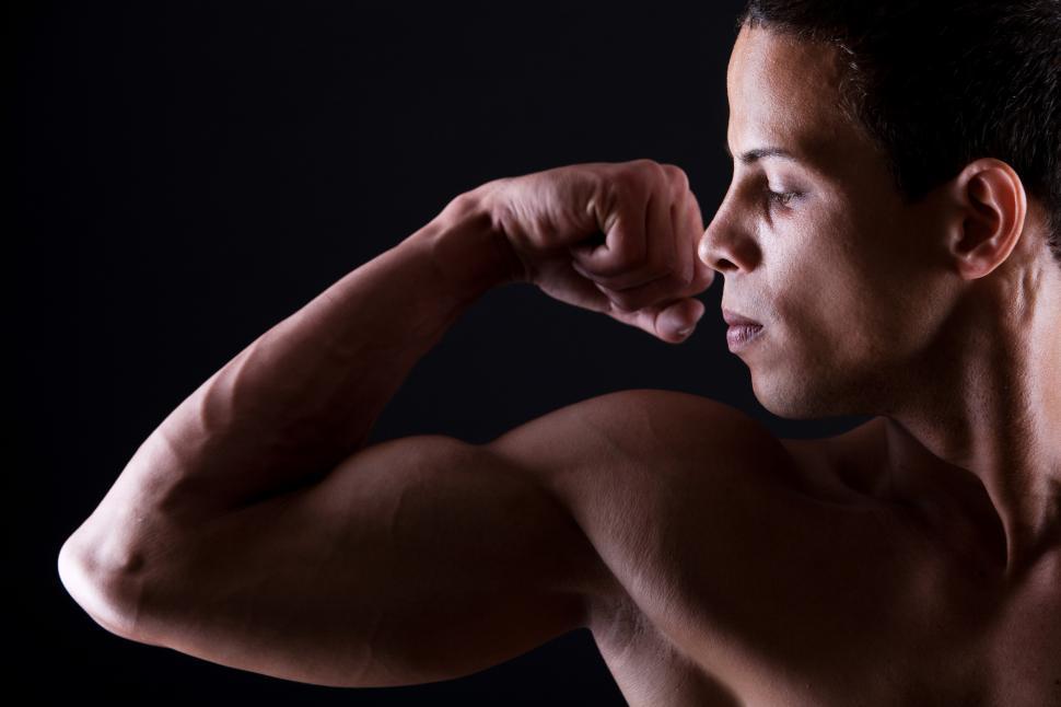 Free Image of Muscular man showing his strong biceps 