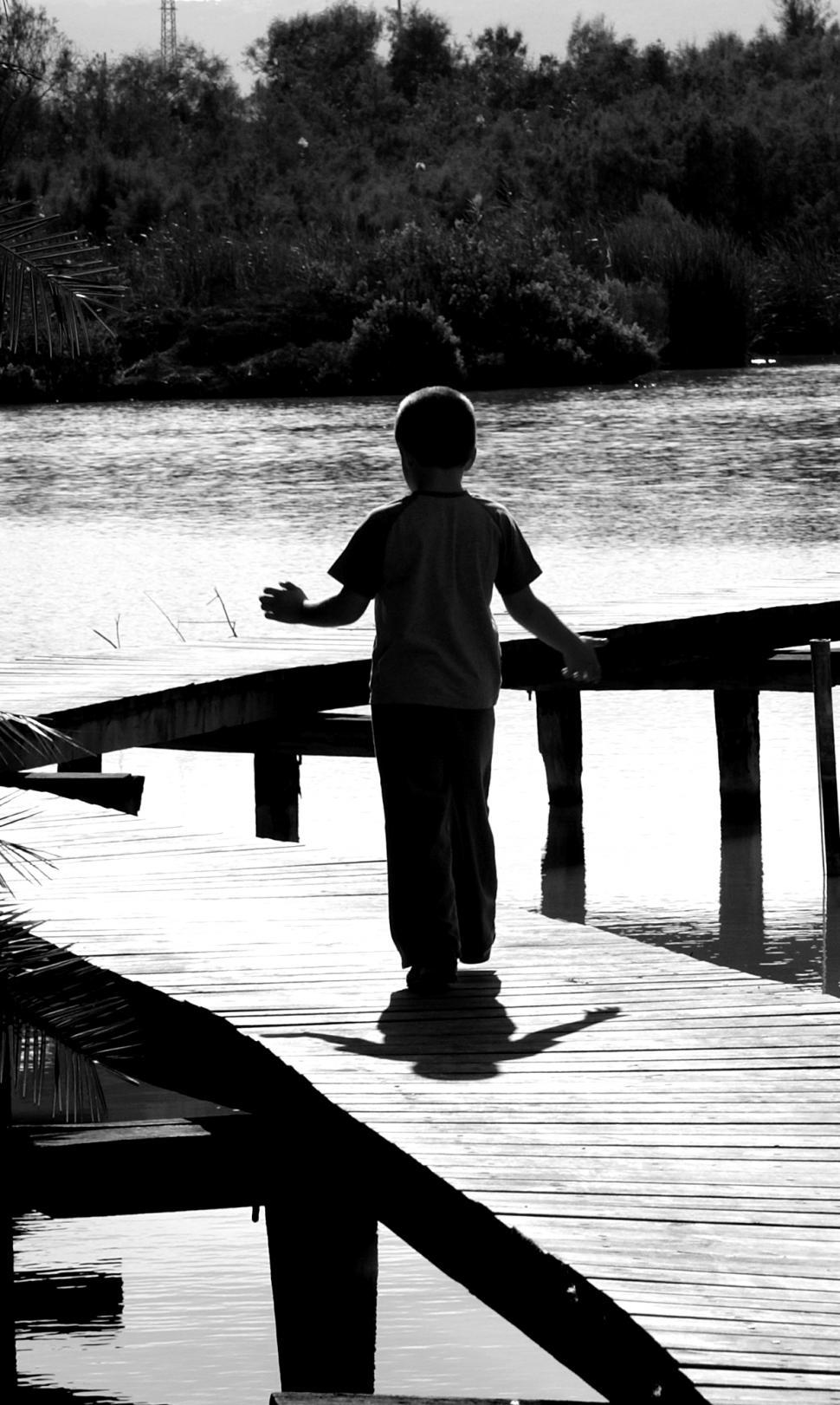 Free Image of A boy on a bridge 