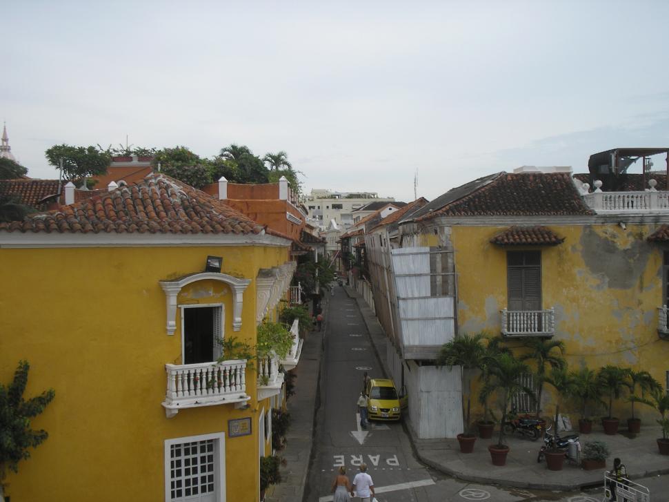 Free Image of City Street With Yellow Buildings 