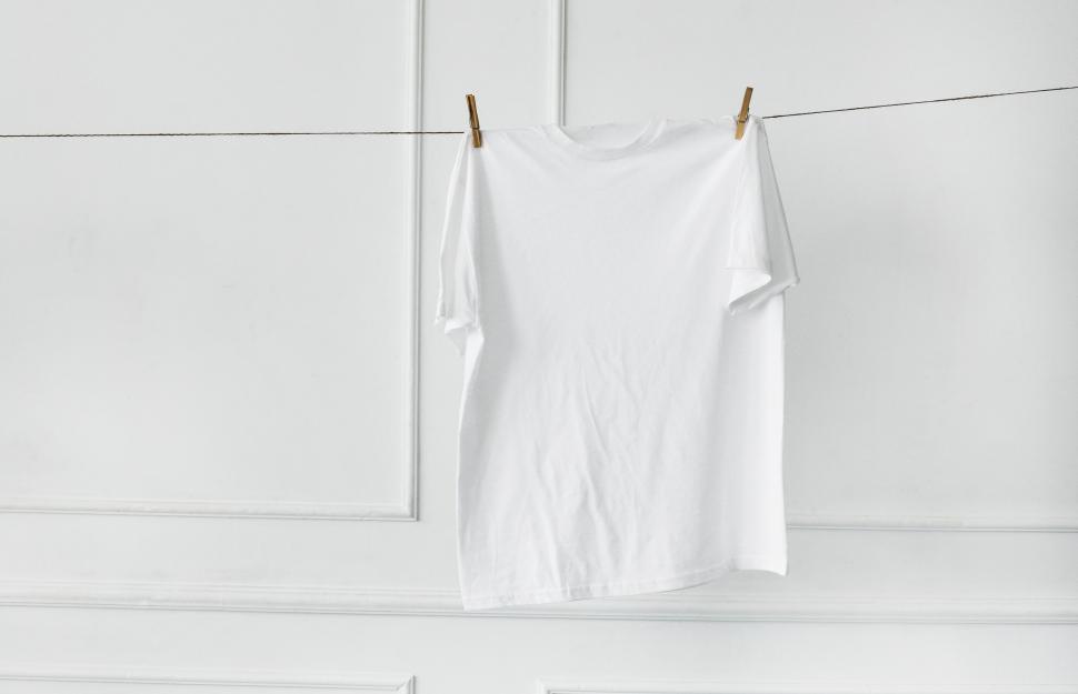 Free Image of White shirt hanging on clothesline by the wall 