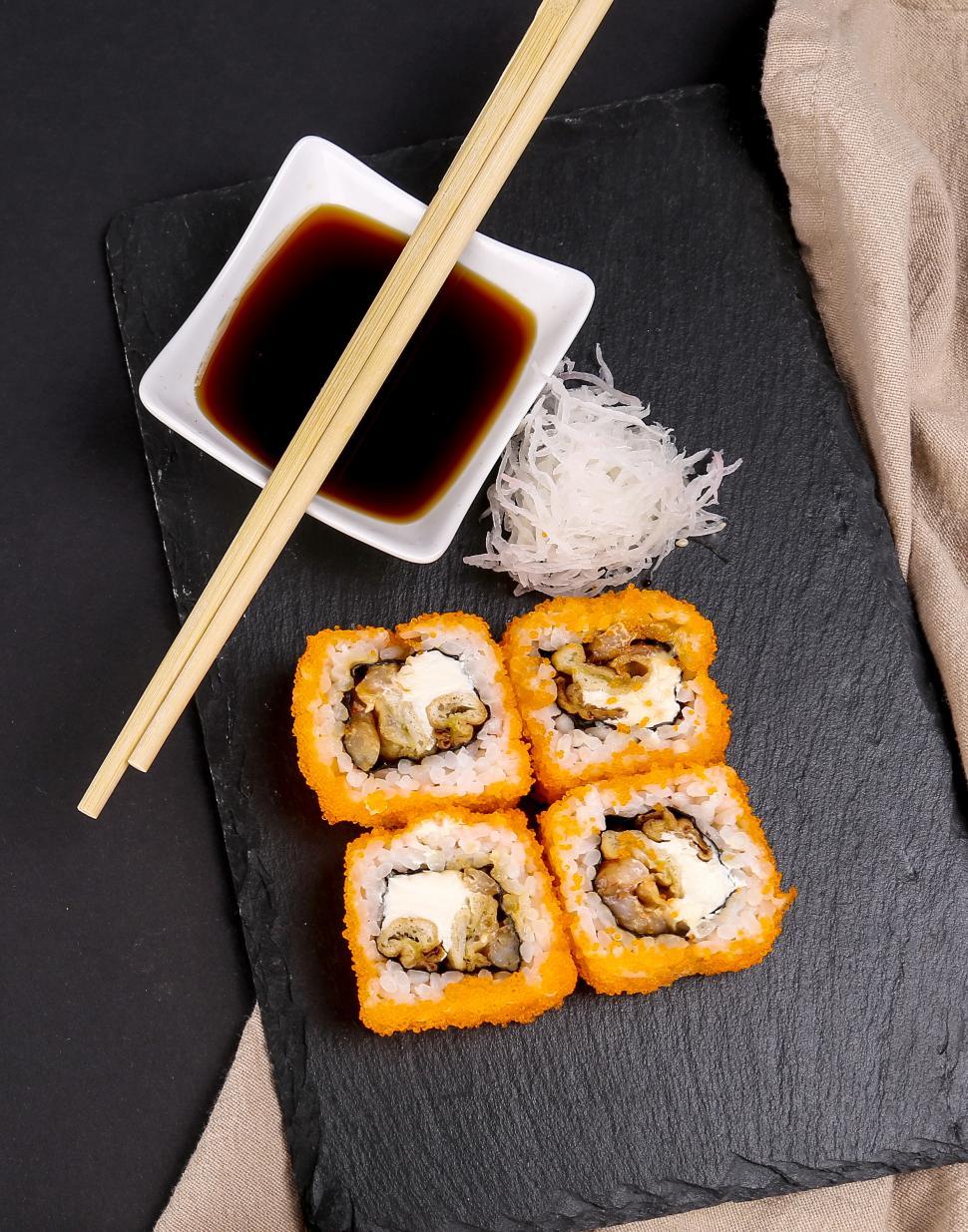 Free Image of Delicious sushi with chopsticks 