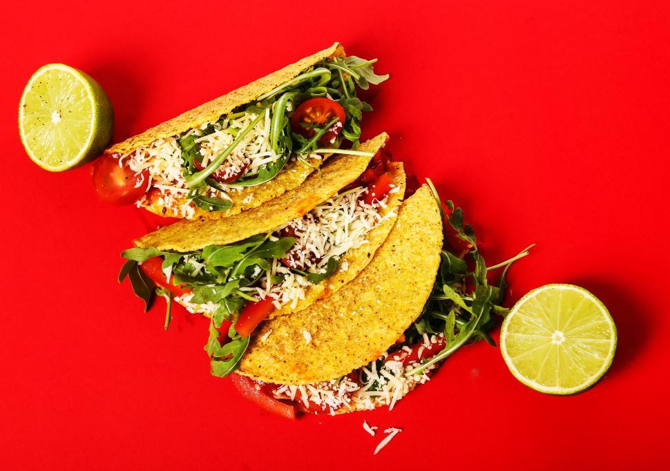 Free Image of Three tacos, red background 