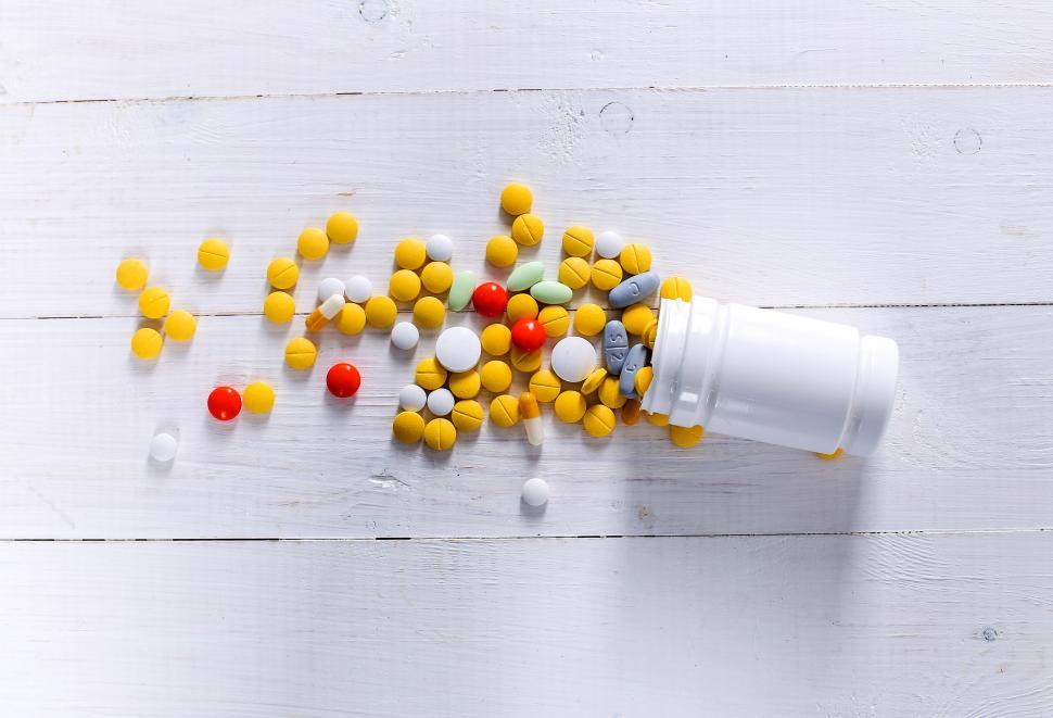Free Image of Pills spilling from a bottle 