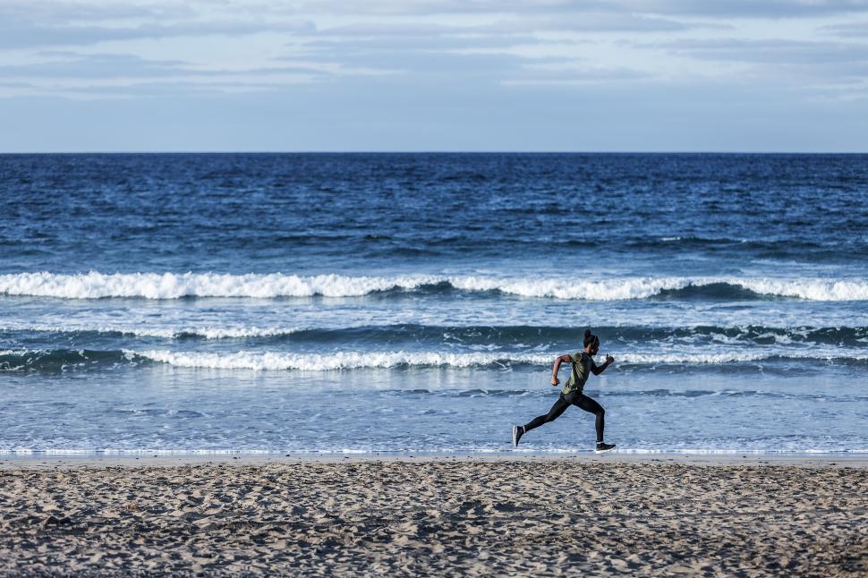 Download Free Stock Photo of Anonymous black sportsman running near sea 