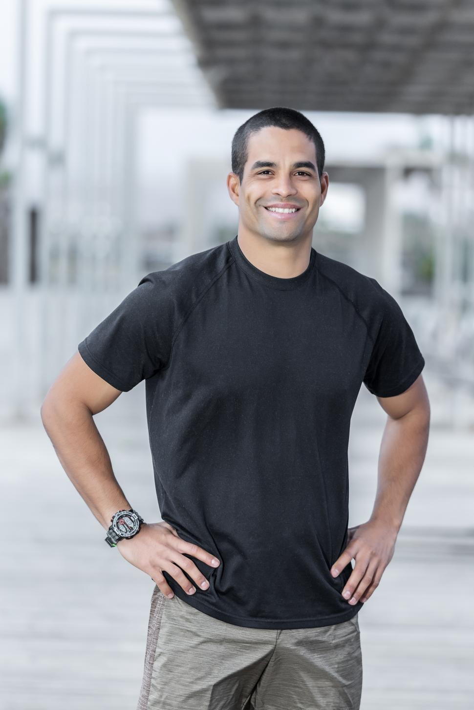 Download Free Stock Photo of Handsome personal trainer with friendly smile 