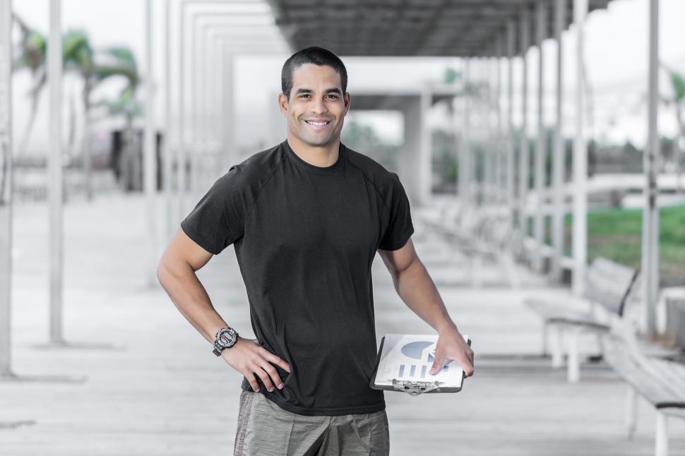 Free Image of Smiling sport instructor with clipboard 