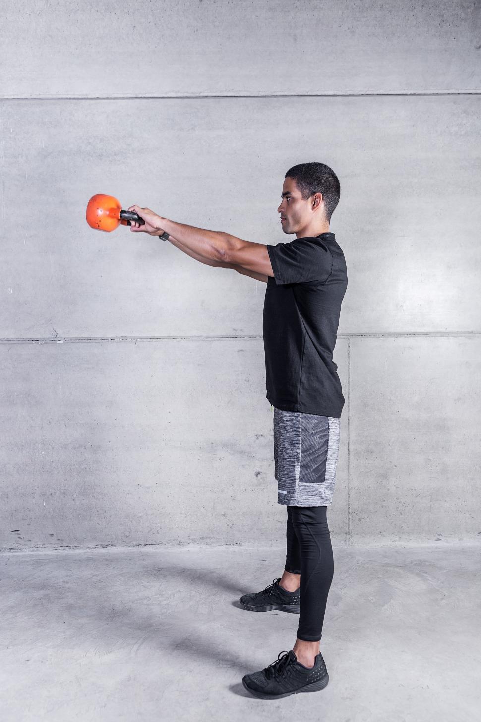 Download Free Stock Photo of Man doing kettlebell swings 