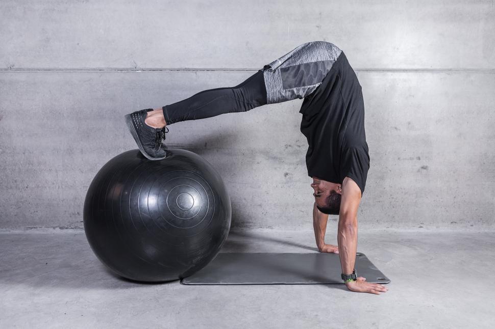 Free Image of Personal coach doing abs exercise on fitness ball 