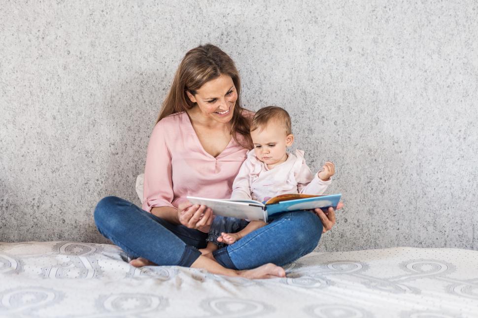 Download Free Stock Photo of Mother reading story to her daughter 