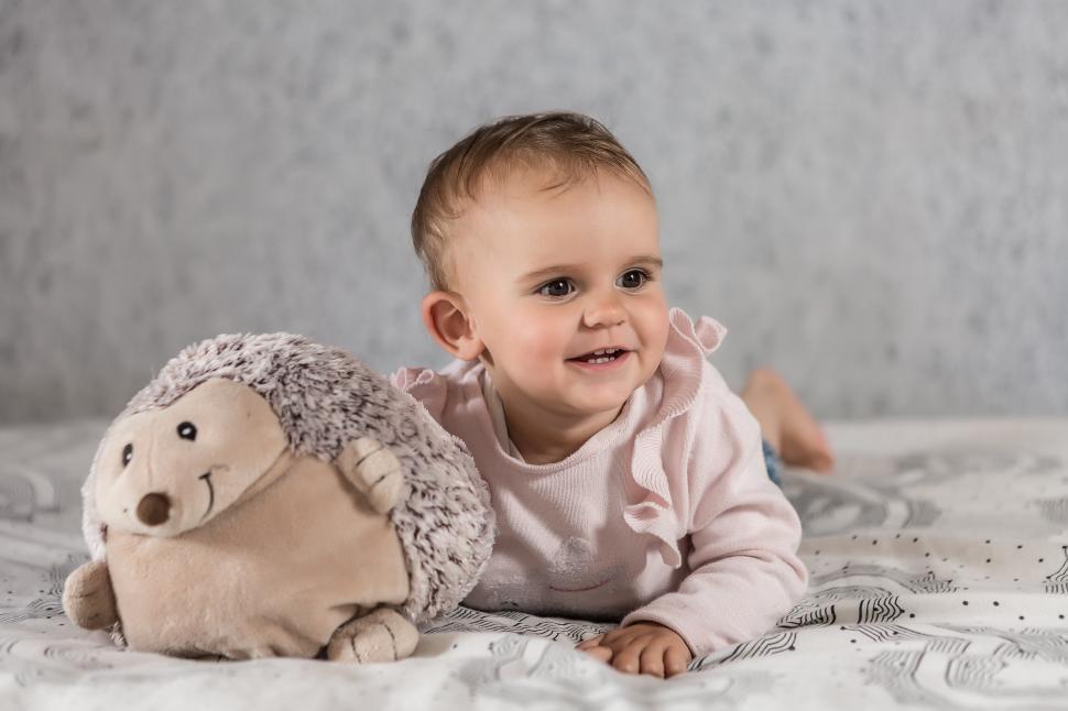 Download Free Stock Photo of Baby on bed with toy 