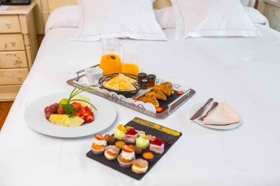 Free Image of Desserts and fruits for breakfast on bed 