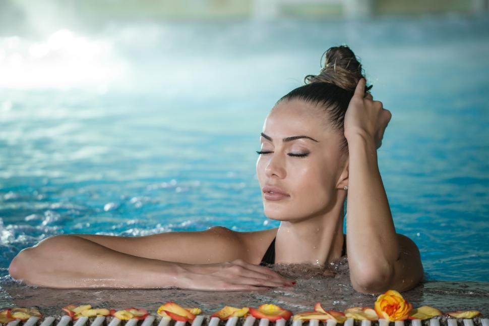 Download Free Stock Photo of Sensual woman touching wet hair in pool 