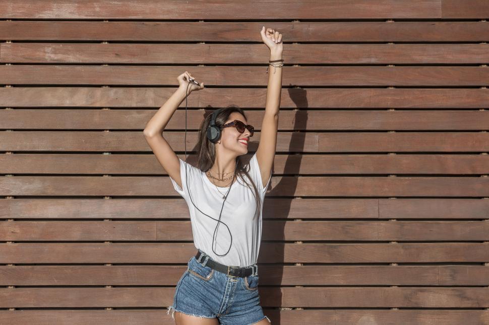 Free Image of Energetic woman listening to music and dancing 