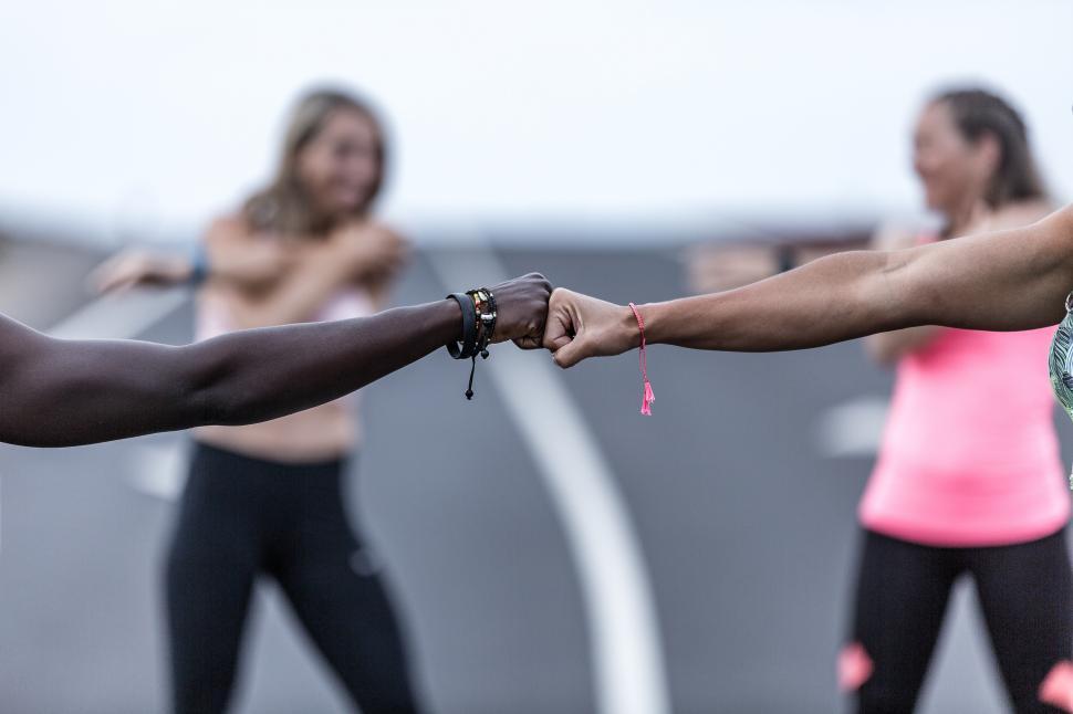 Free Image of Crop diverse friends bumping fists during training 