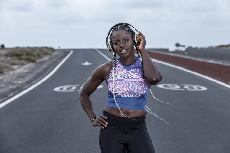 Free Image of Positive black sportswoman listening to music 