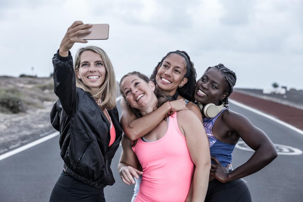 Free Image of Delighted diverse sportswomen taking selfie during workout 