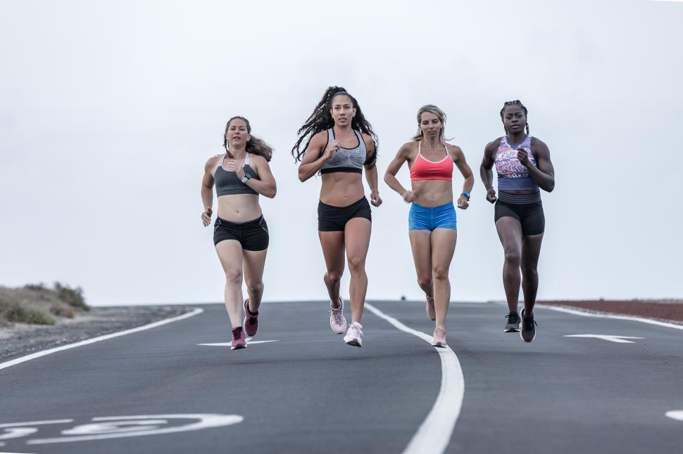 Free Image of Multiethnic female runners on road in outskirts 