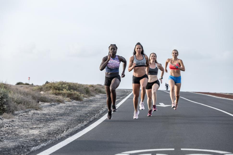 Free Image of Determined multiethnic sportswomen running together 