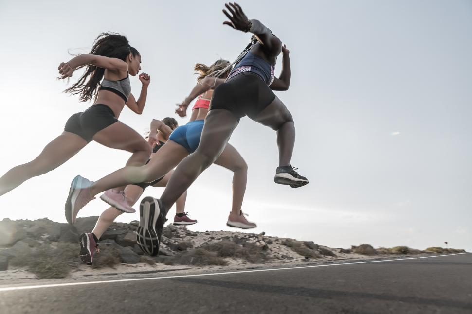 Free Image of Anonymous diverse sportswomen sprinting in outskirts 