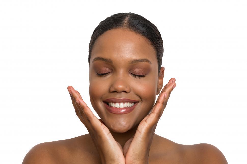 Free Image of Happy woman touching her perfect skin with her eyes closed. 