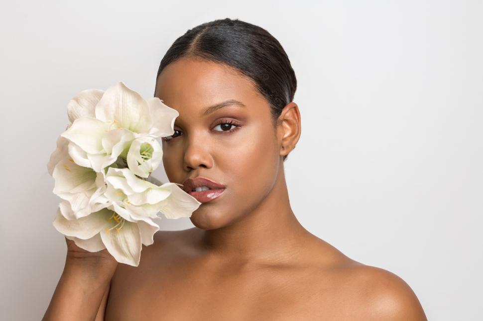 Free Image of Serious woman with makeup and flowers 