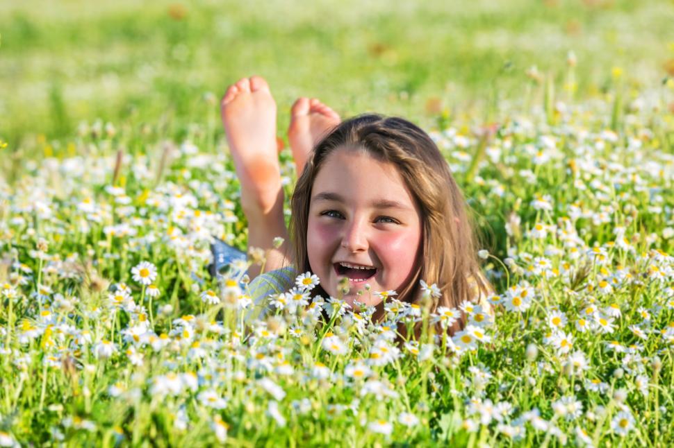Free Image of Joyful little girl enjoying sunny day in summer field 