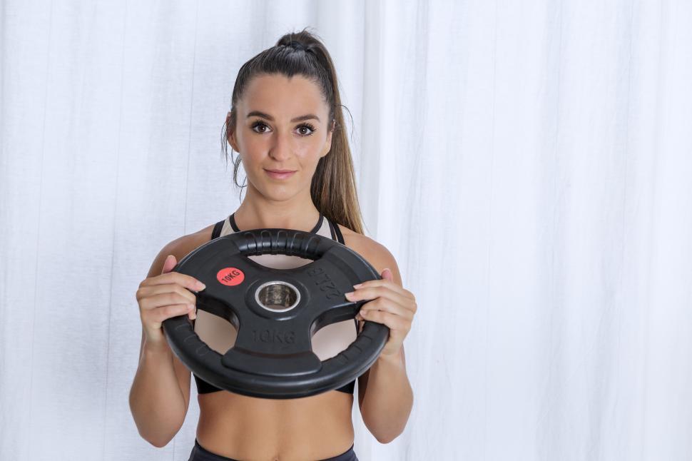 Free Image of Fit woman with weight plate 