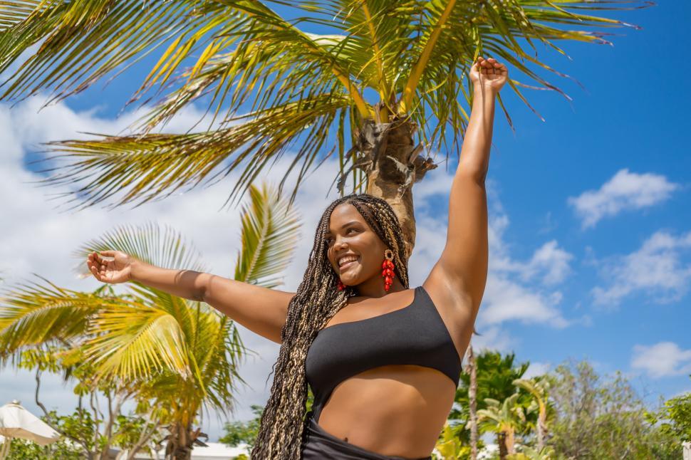 Download Free Stock Photo of Happy African American woman in summer clothes with arms outstretched 