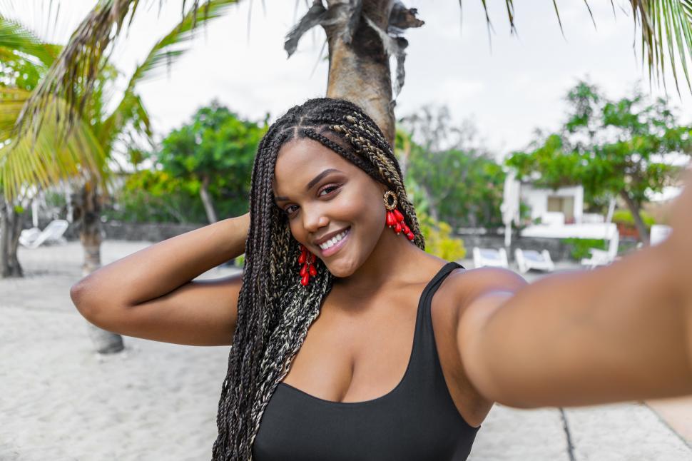 Download Free Stock Photo of Happy African American woman taking a selfie 