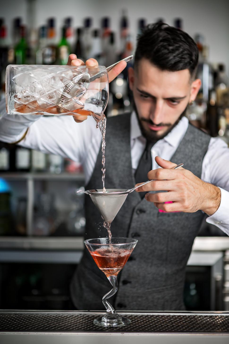 Download Free Stock Photo of Barman filling glass with cocktail 