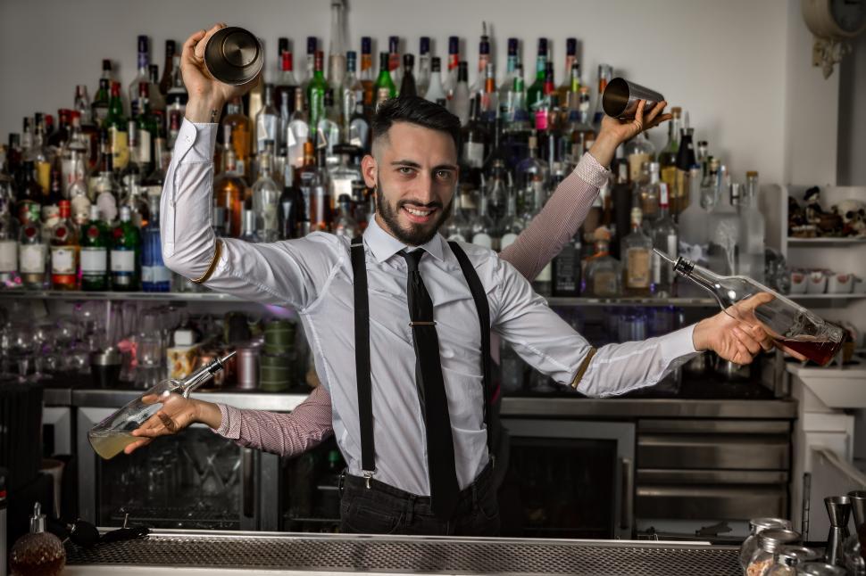 Download Free Stock Photo of Bartenders with shakers and bottles in pub 