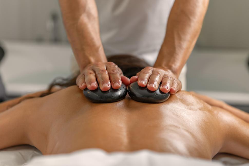 Free Image of Close rear view of woman having back massage with stones 