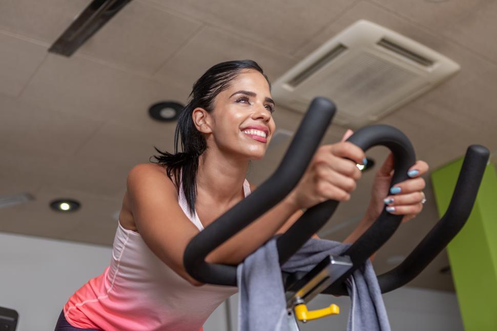 Free Image of Low angle view of a young adult woman in sportswear exercising 