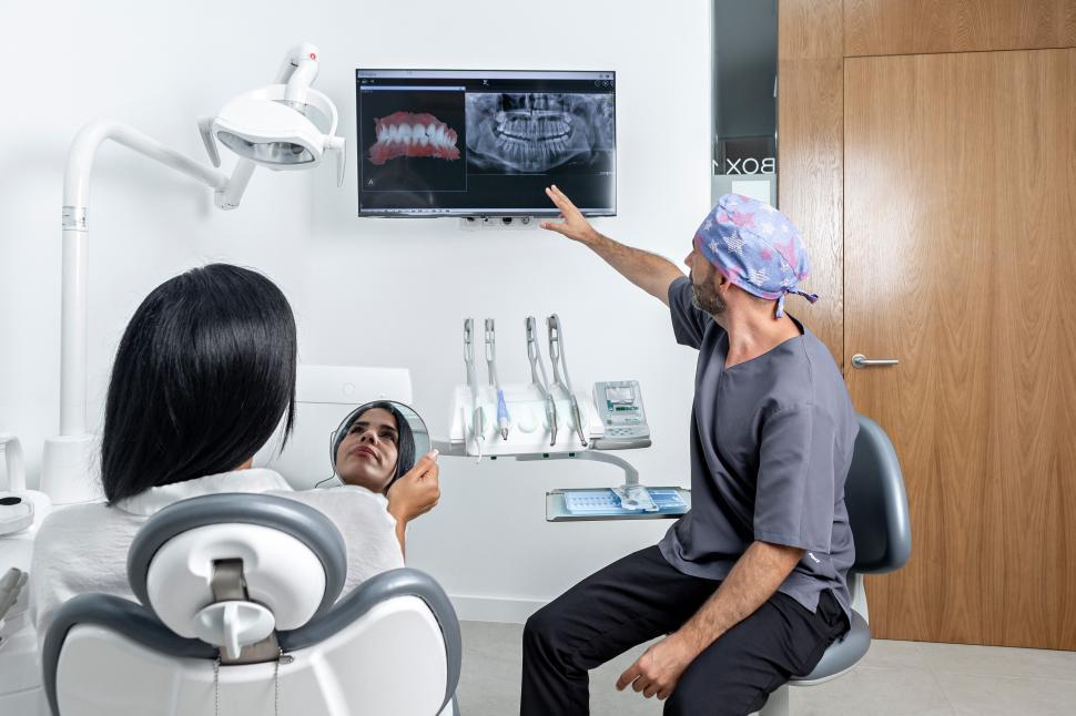 Free Image of Dentist showing a x-ray to a patient 
