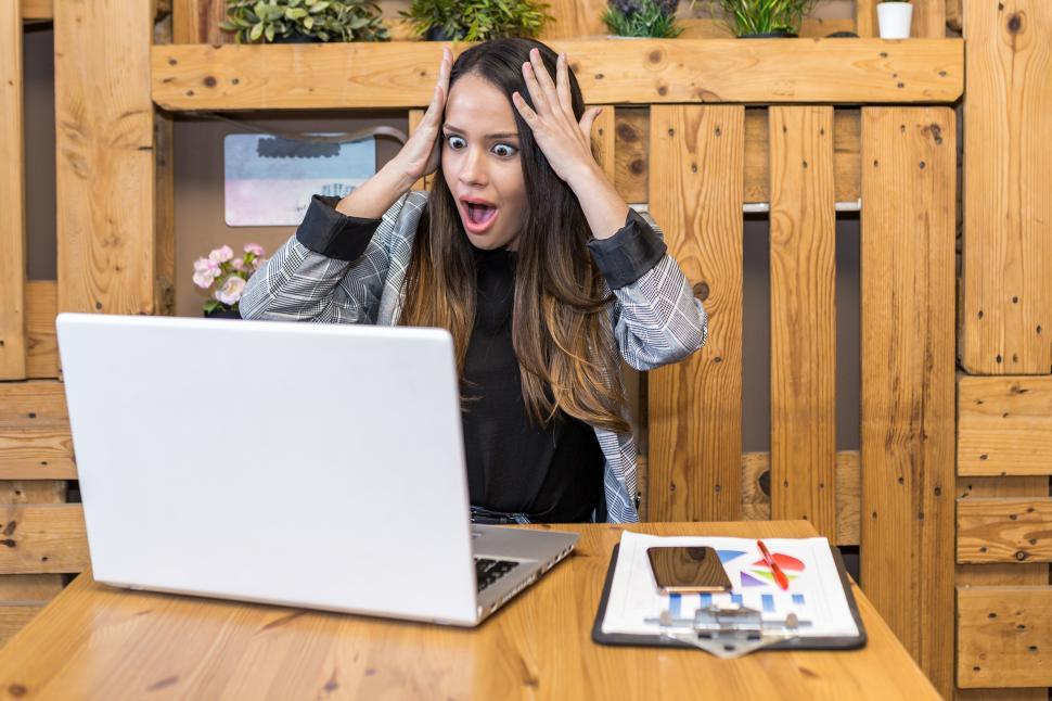 Free Image of Shocked woman reading unexpected information on laptop 