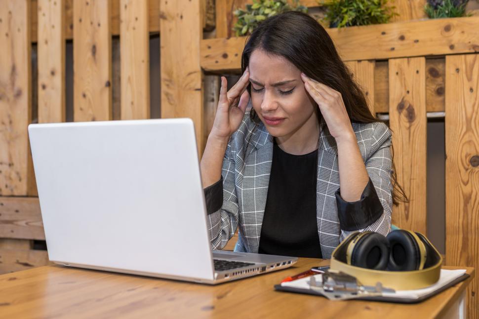 Free Image of Exhausted woman working on laptop in cafe 