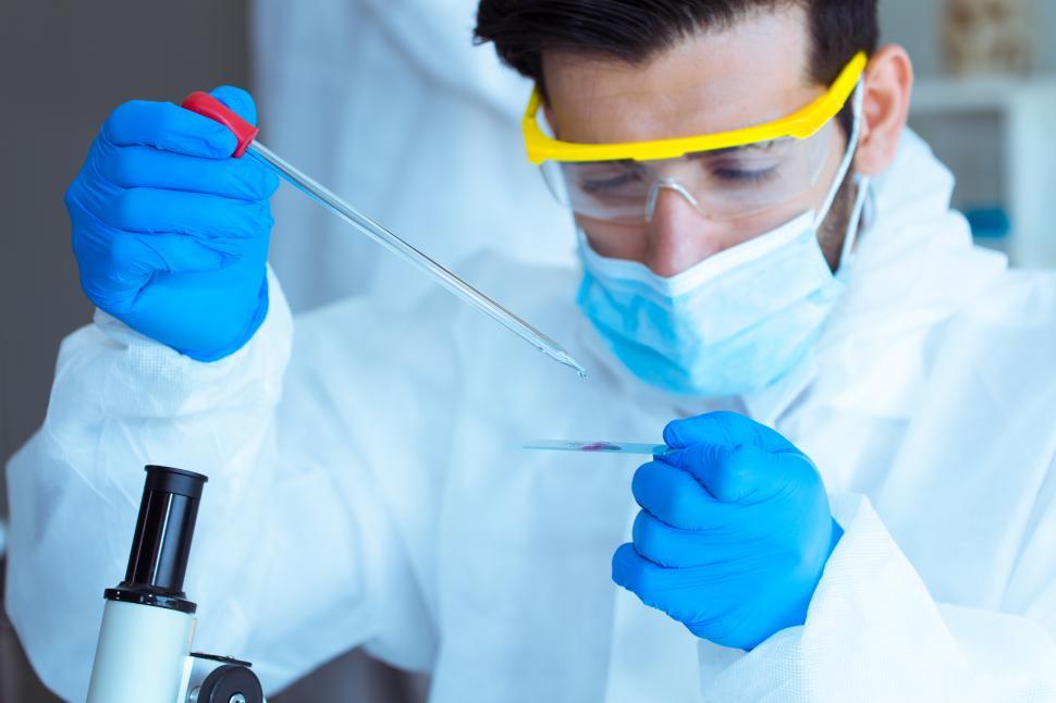 Free Image of Scientists in laboratory conducting experiment with a blood sample 