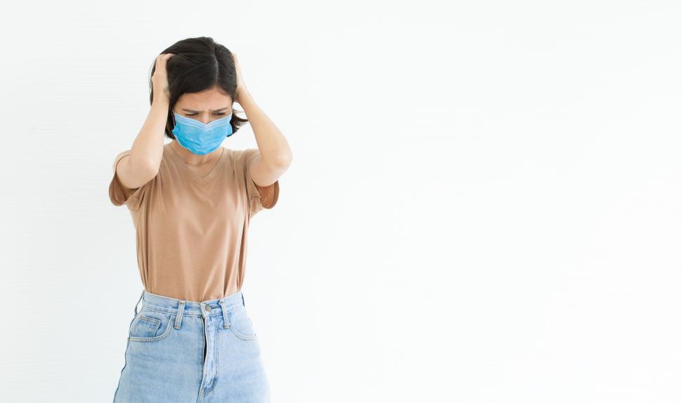 Free Image of Woman wearing surgical mask stressed with the outbreak of disease 