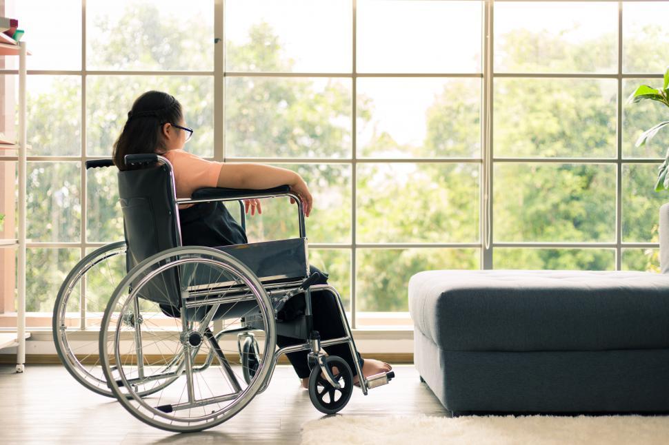 Free Image of Young girl sitting in a wheelchair alone 