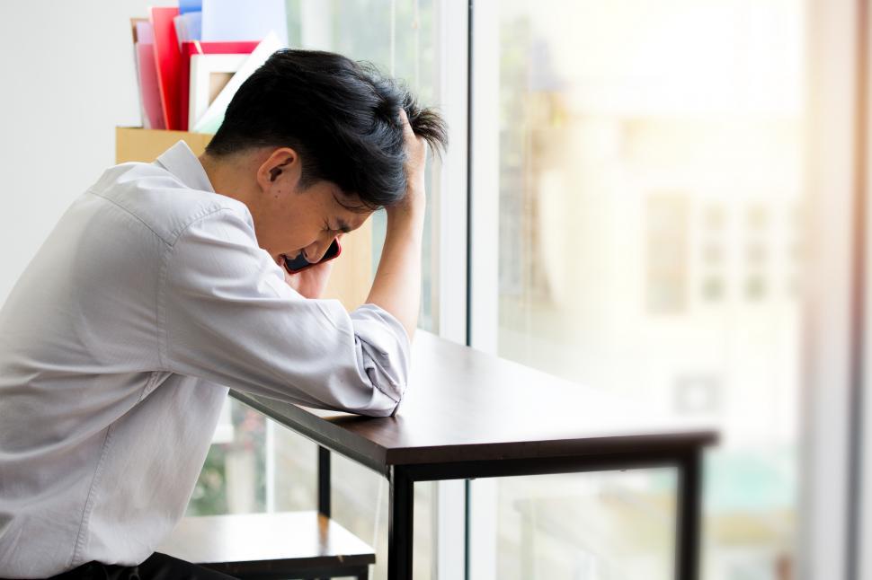 Download Free Stock Photo of The male employee was stressed because he was fired from work. 